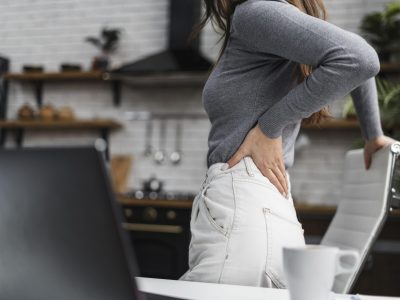 side-view-woman-having-a-backache-while-working-from-home-min side-view-woman-having-a-backache-while-working-from-home-min